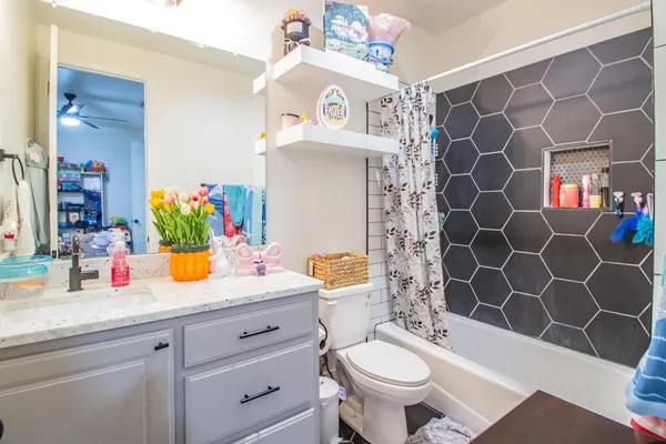 a bathroom with a sink toilet and shower