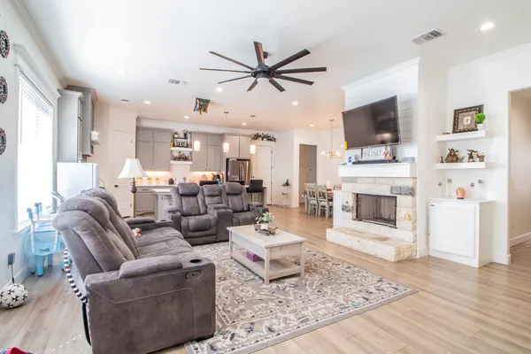 a living room with furniture a fireplace and a flat screen tv