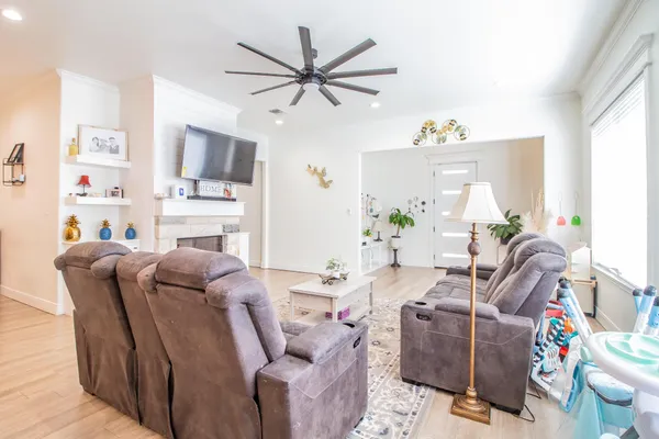 a living room with furniture a flat screen tv and a window