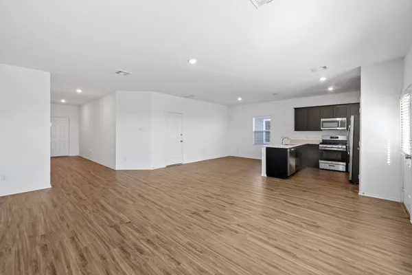 a view of a kitchen with a sink and a refrigerator