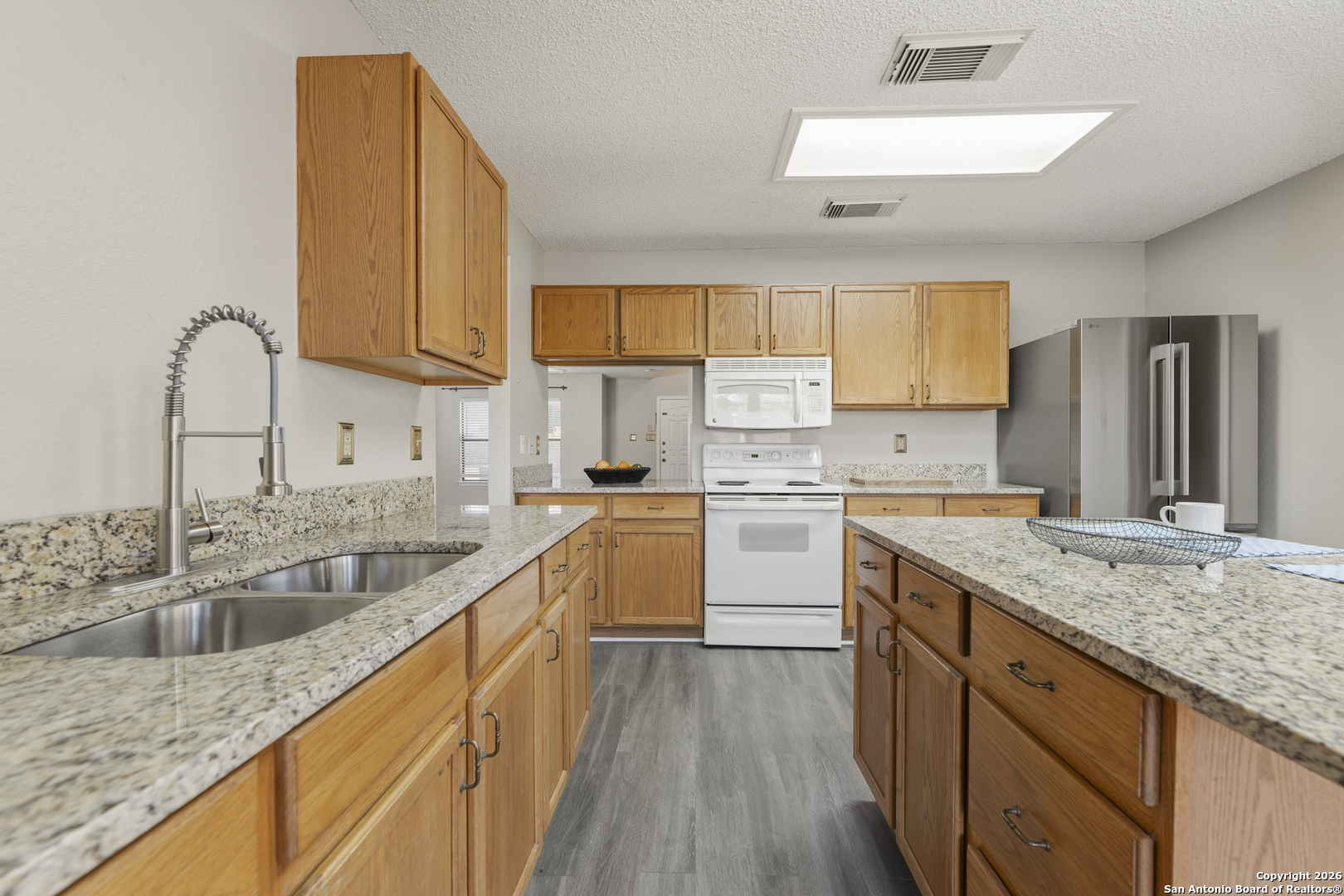 1048 Sycamore Schertz, TX 78154 - Photo 13 of 31 a kitchen with a sink cabinets and window