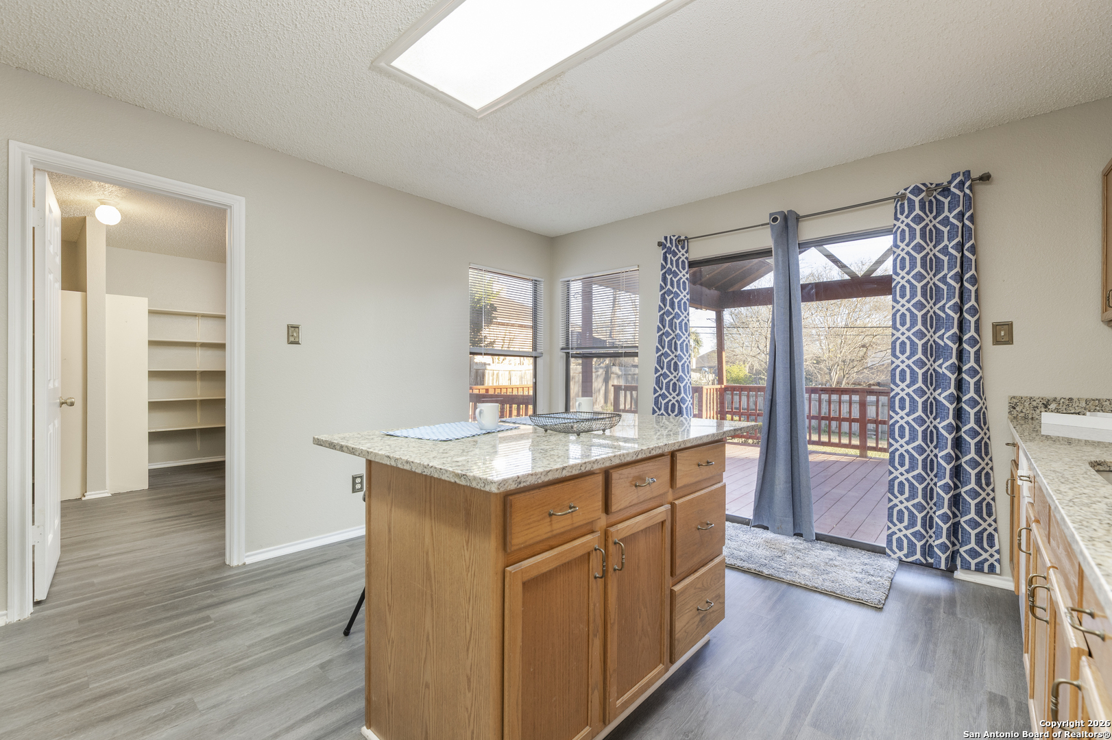 1048 Sycamore Schertz, TX 78154 - Photo 14 of 31 a kitchen with a wooden floor and a large window