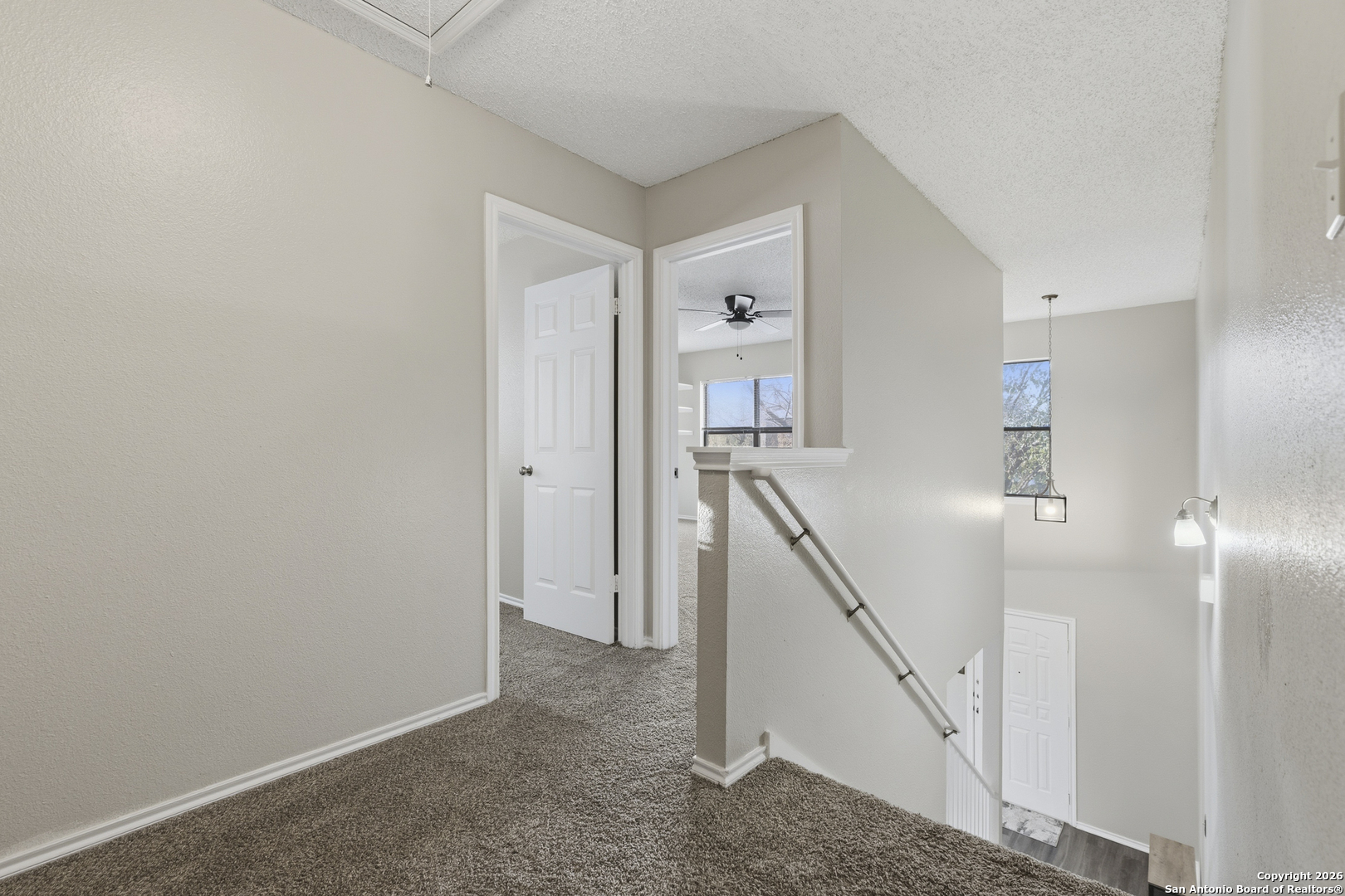1048 Sycamore Schertz, TX 78154 - Photo 17 of 31 a view of a hallway with wooden floor and stairs
