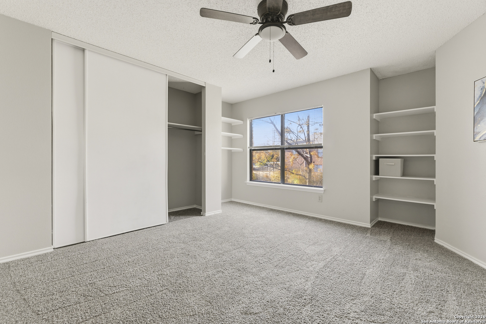 1048 Sycamore Schertz, TX 78154 - Photo 18 of 31 an empty room with windows and ceiling fan