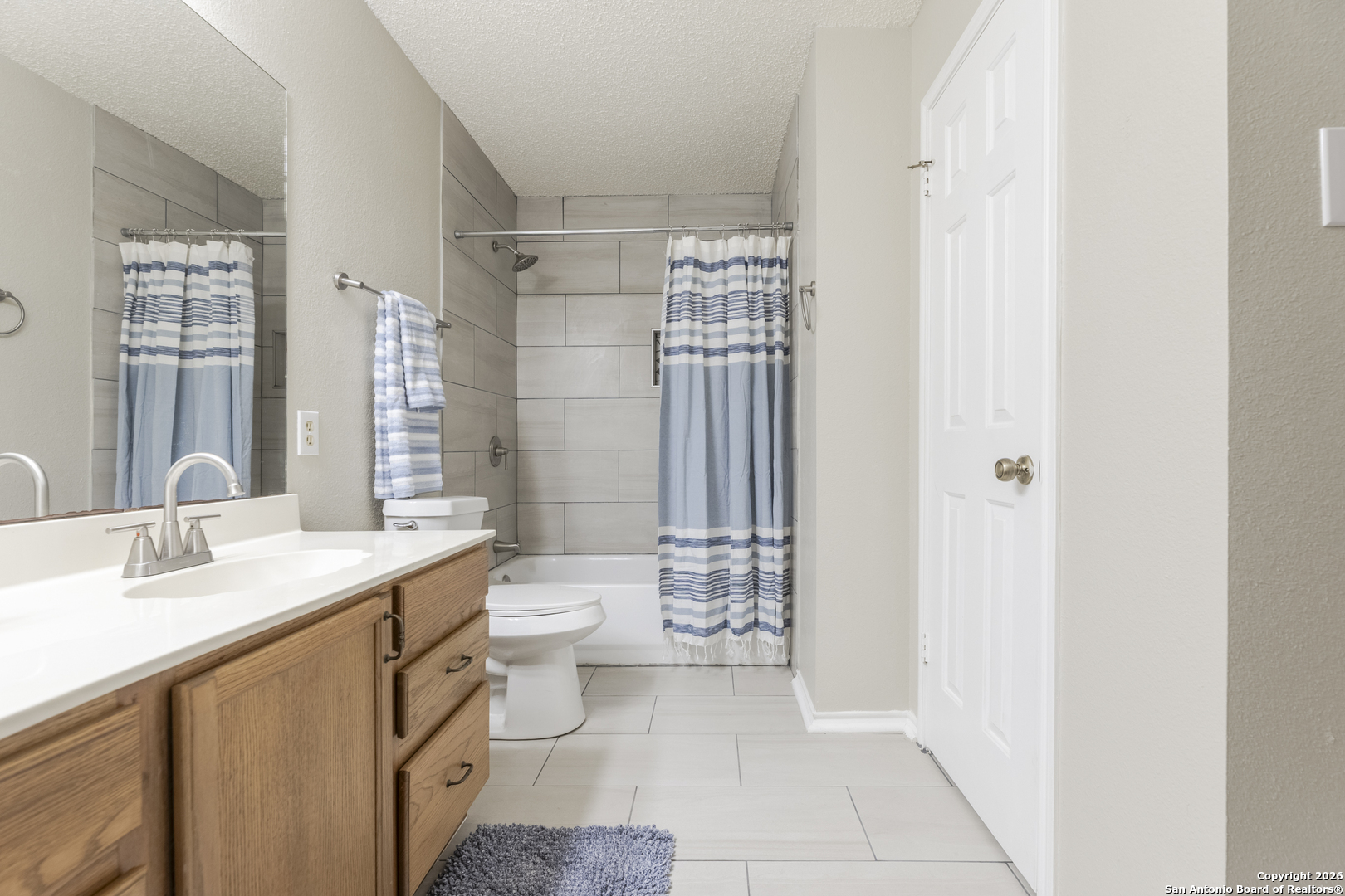 1048 Sycamore Schertz, TX 78154 - Photo 25 of 31 a bathroom with a sink a toilet and shower