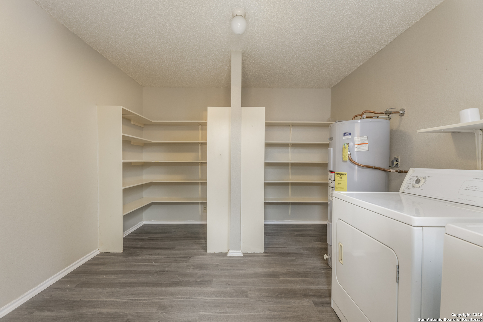 1048 Sycamore Schertz, TX 78154 - Photo 27 of 31 a view of walk in closet with empty racks