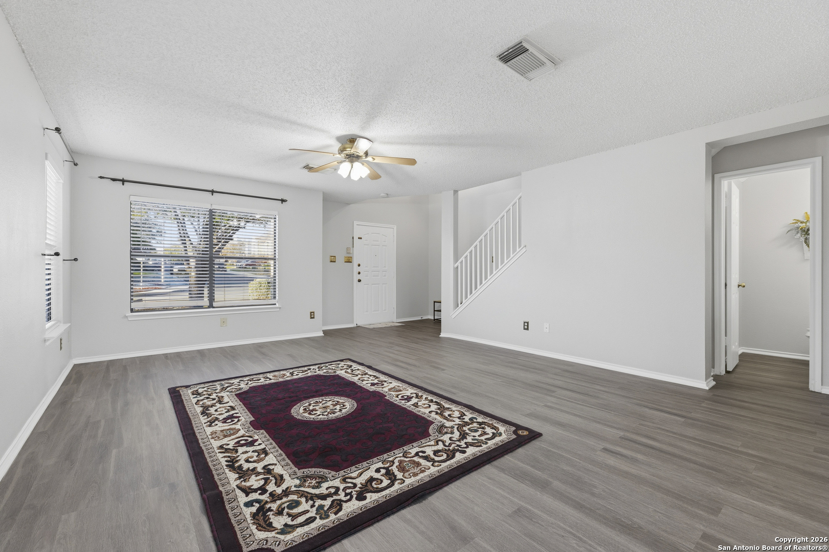 1048 Sycamore Schertz, TX 78154 - Photo 5 of 31 a view of an empty room with window and wooden floor