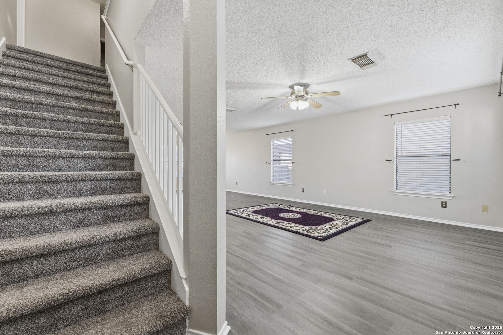 1048 Sycamore Schertz, TX 78154 - Photo 7 of 31 a view of room with stairs and wooden floor