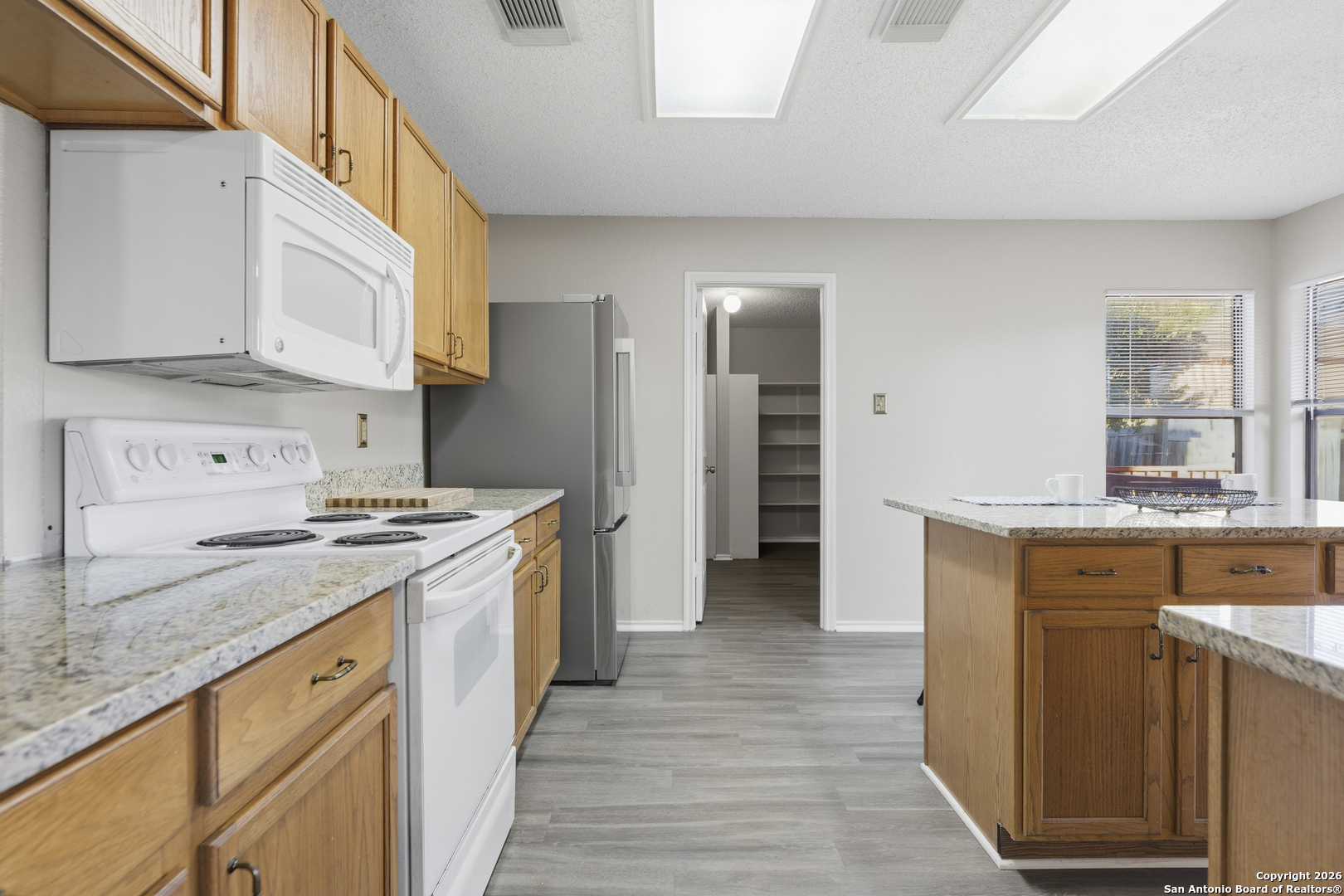 1048 Sycamore Schertz, TX 78154 - Photo 9 of 31 a kitchen with stainless steel appliances granite countertop a stove and a sink