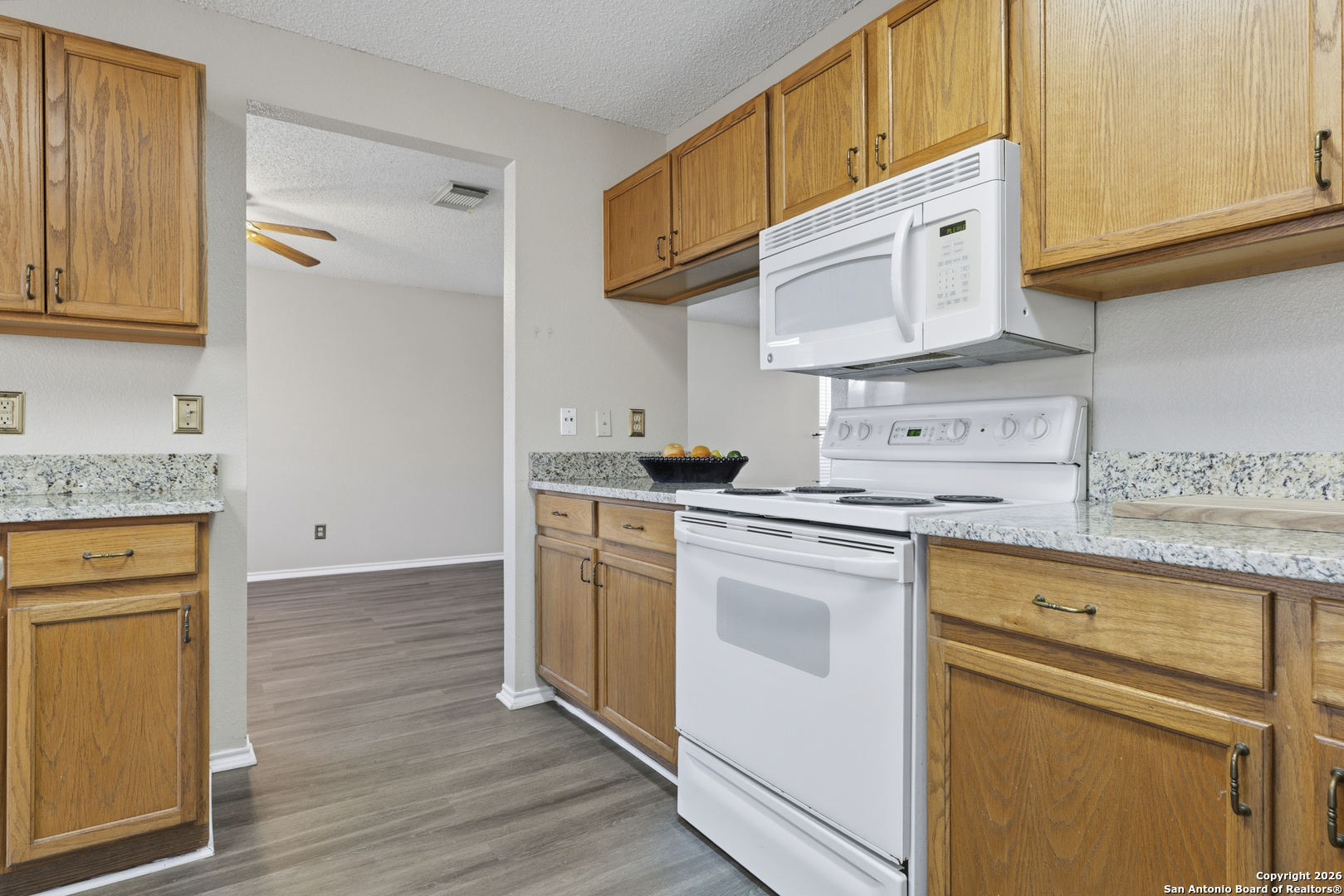 1048 Sycamore Schertz, TX 78154 - Photo 10 of 31 a kitchen with stainless steel appliances granite countertop a sink stove and cabinets
