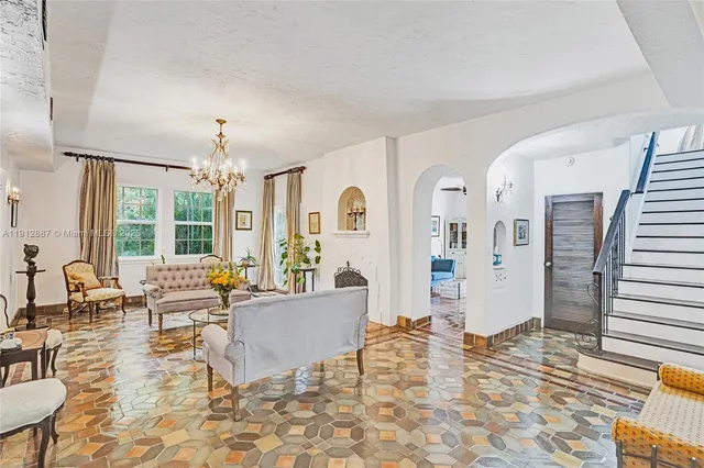 a living room with furniture and a floor to ceiling window
