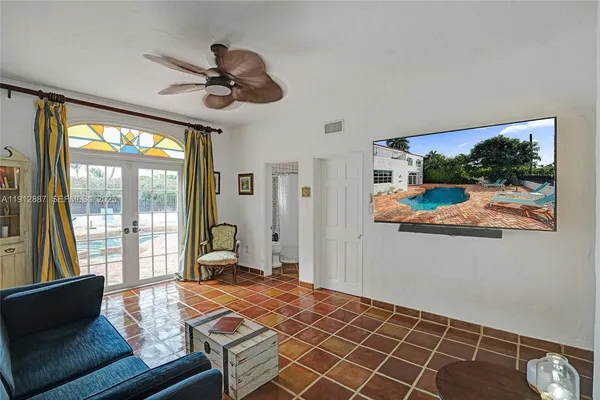 a dining room with furniture window and wooden floor
