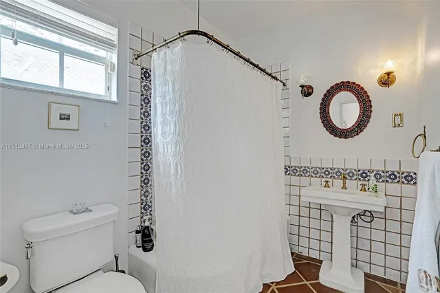 a spacious bedroom with a bed and a window