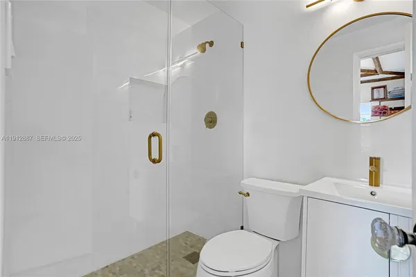 a bathroom with a sink a toilet and a mirror