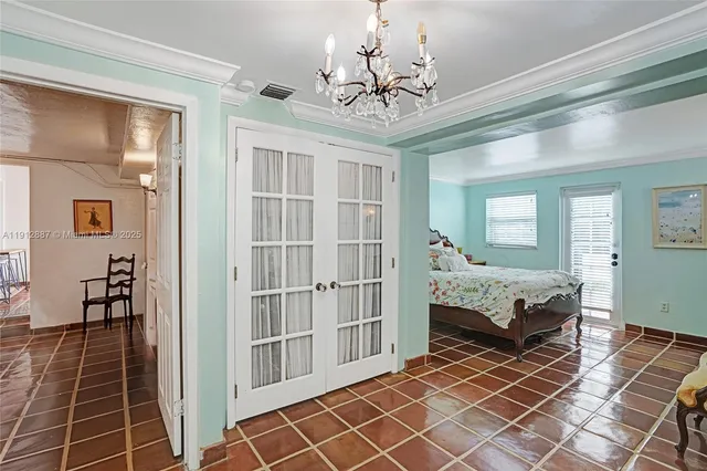 a bedroom with a bed and a chandelier