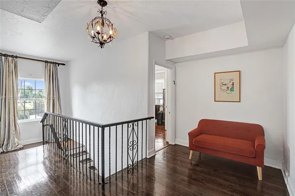 a living room with furniture fireplace and wooden floor