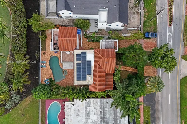 an aerial view of residential house with outdoor space and swimming pool