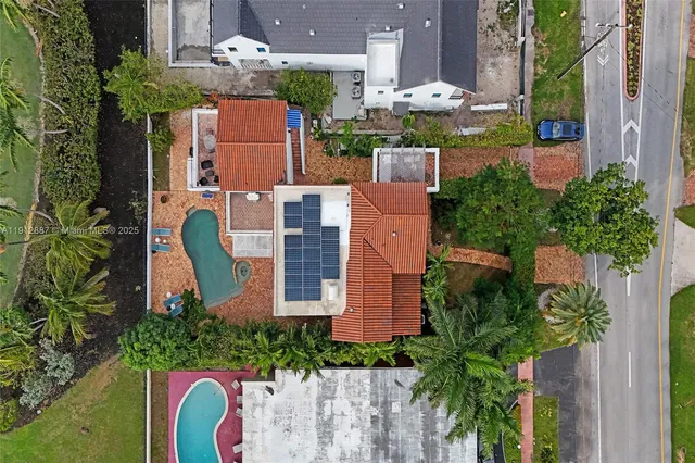an aerial view of residential house with outdoor space and trees
