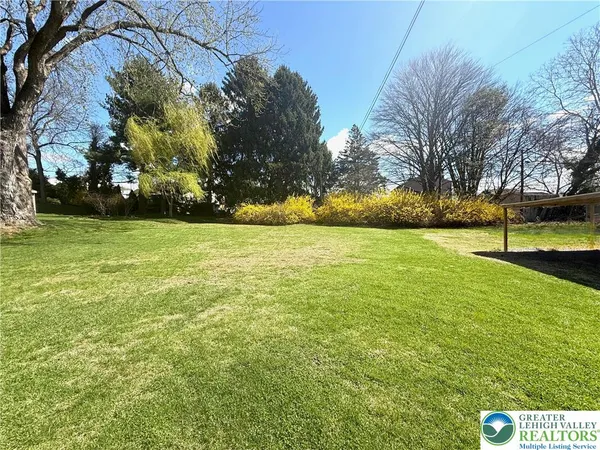 a view of yard with swimming pool and trees