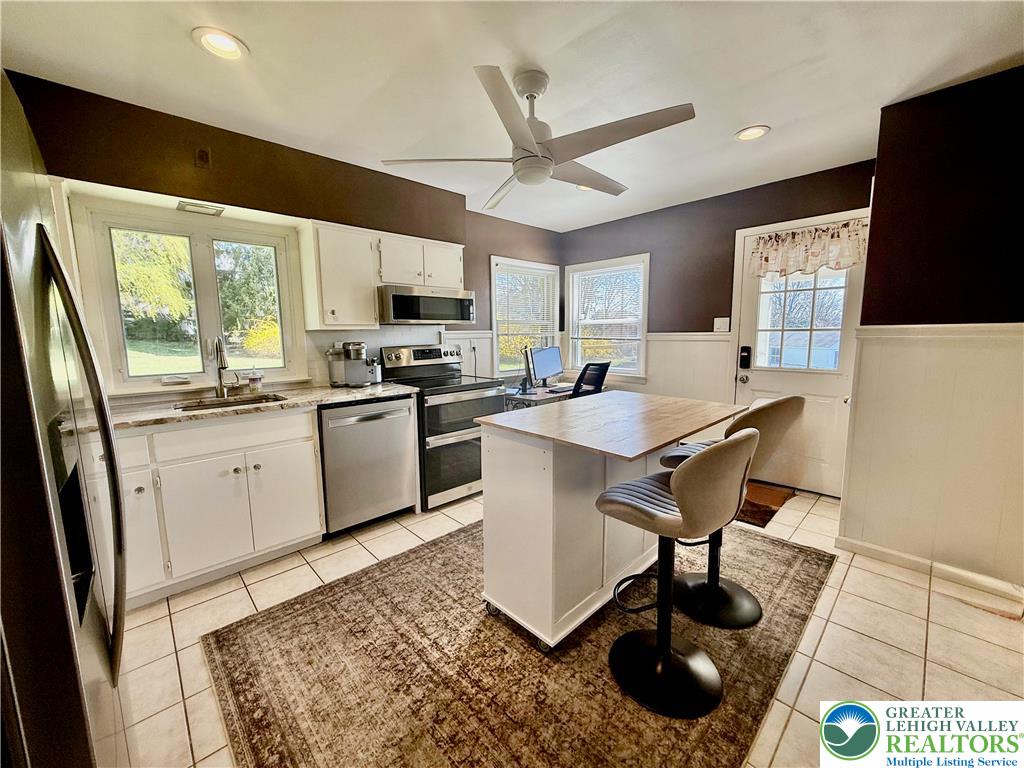 2701 Nazareth Road Easton, PA 18045 - Photo 5 of 13 a kitchen with a sink a counter top space appliances and a window