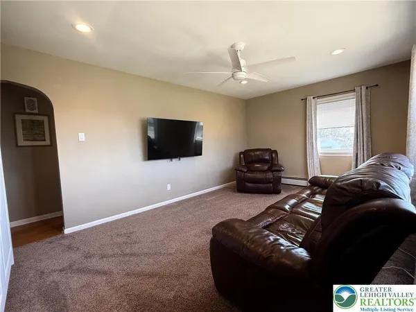 a bedroom with a bed and a television