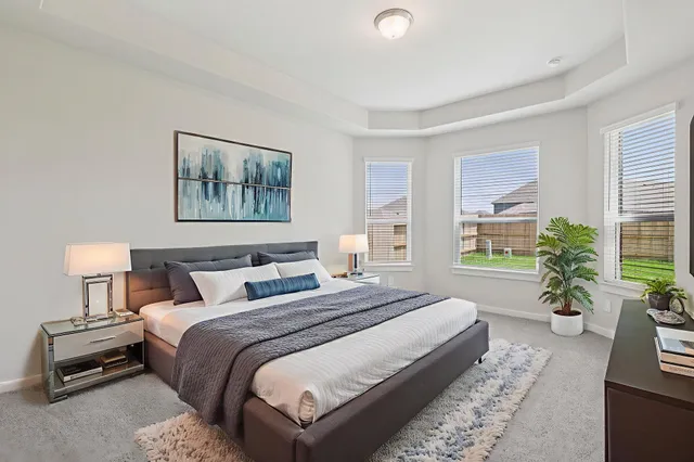a bedroom with bed and a potted plant