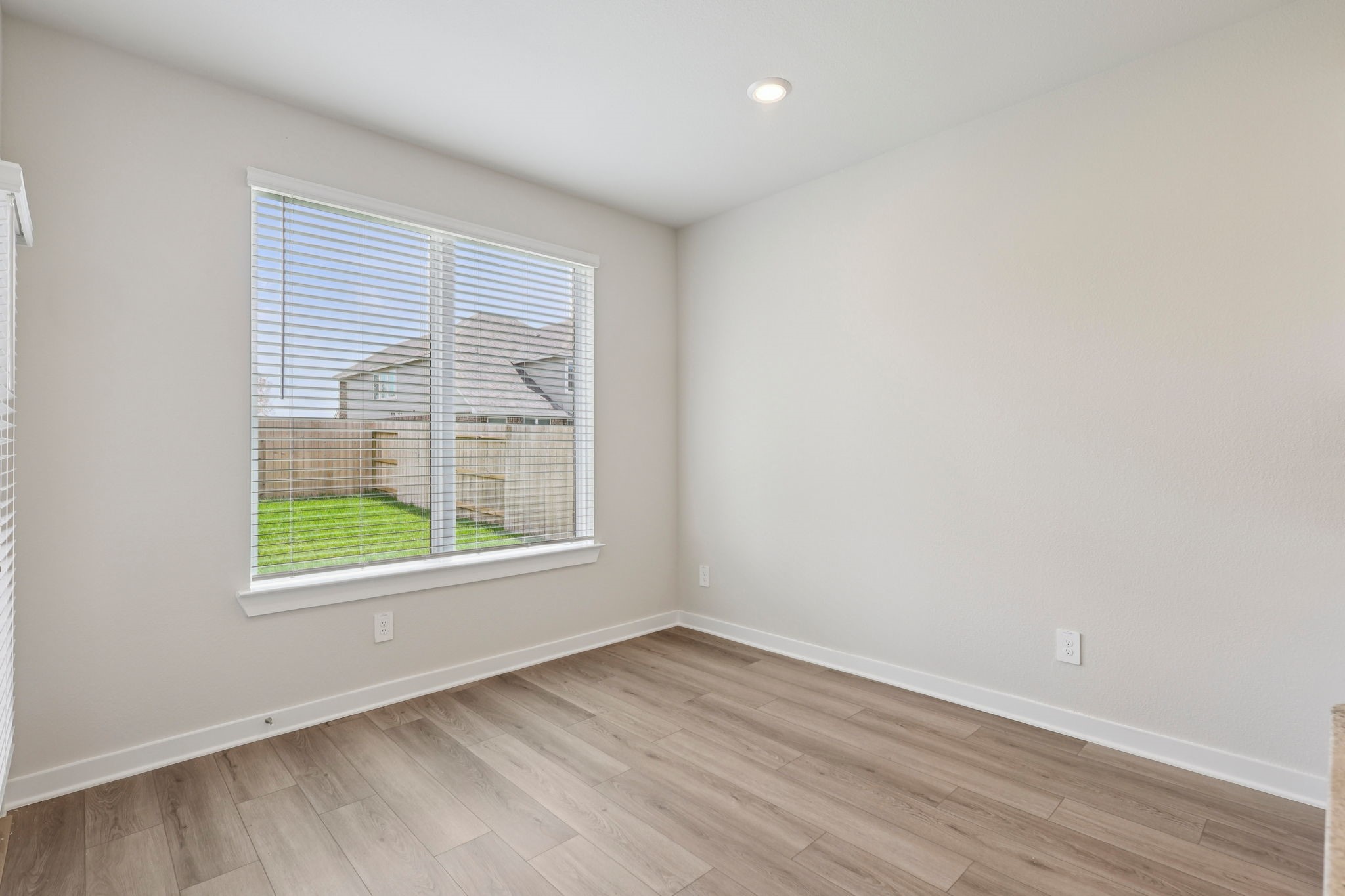 5519 Handlewood Lane Rosenberg, TX 77471 - Photo 11 of 38 an empty room with wooden floor and windows