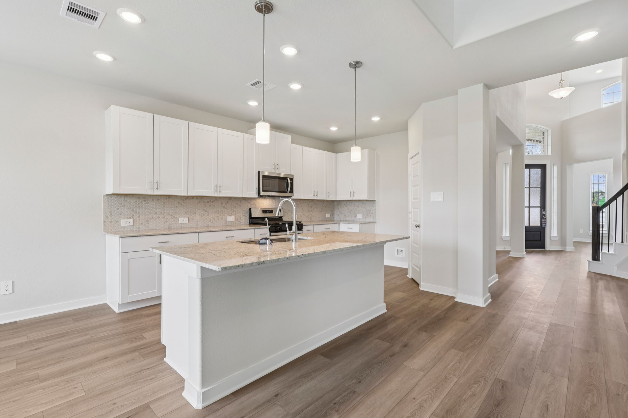 5519 Handlewood Lane Rosenberg, TX 77471 - Photo 13 of 38 a kitchen with kitchen island a sink stainless steel appliances and wooden floor