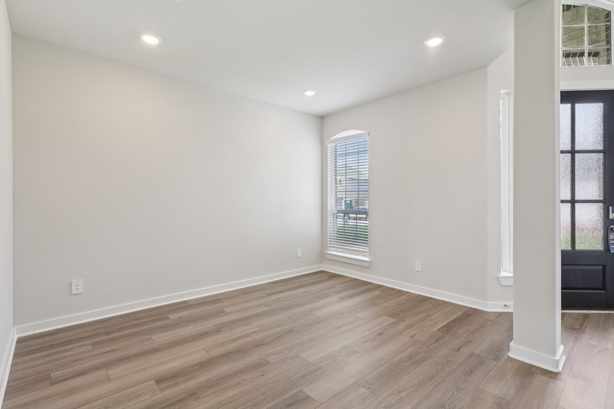 5519 Handlewood Lane Rosenberg, TX 77471 - Photo 5 of 38 wooden floor in an empty room with a window