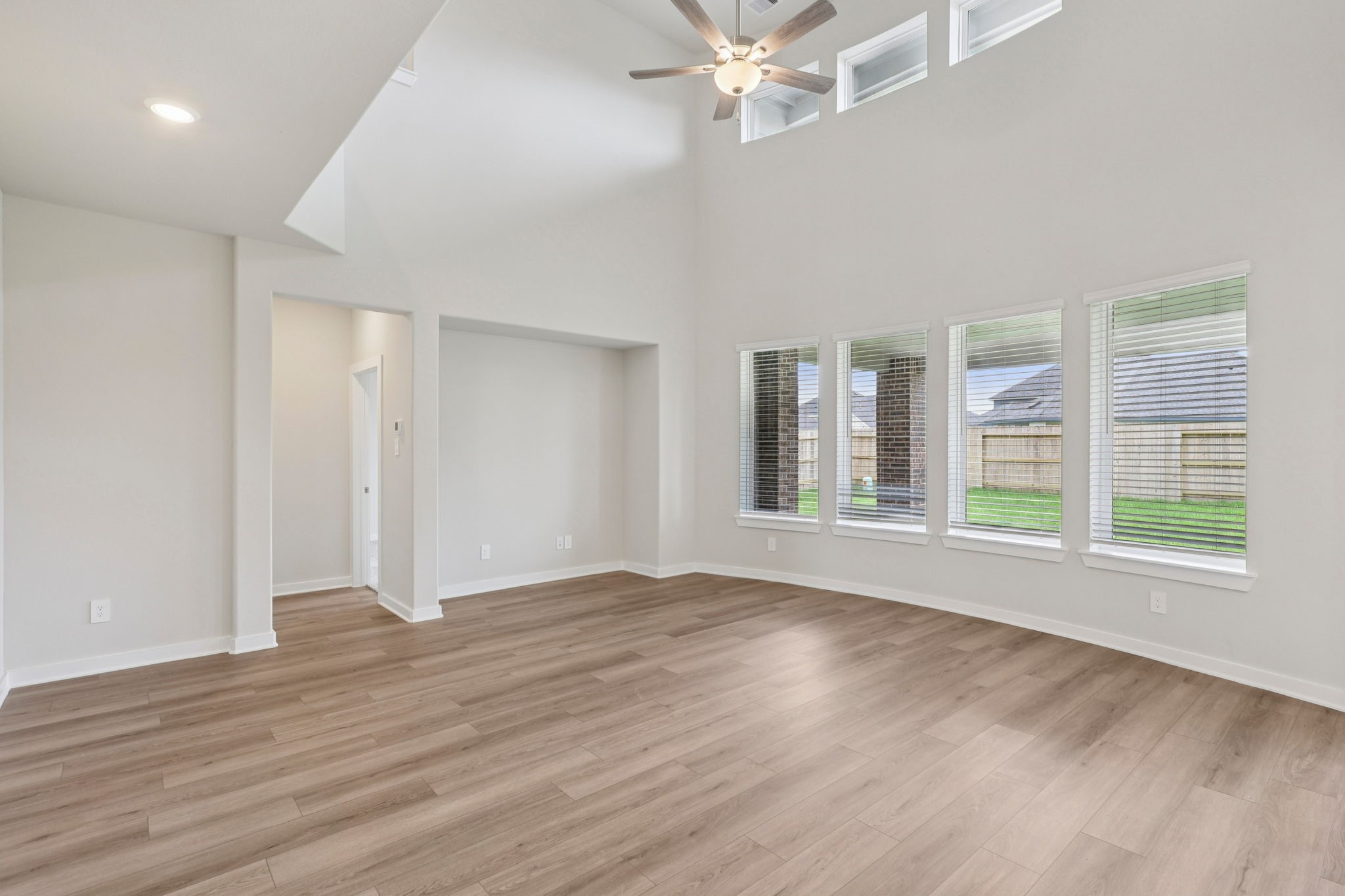 5519 Handlewood Lane Rosenberg, TX 77471 - Photo 8 of 38 a view of an empty room with wooden floor and a window