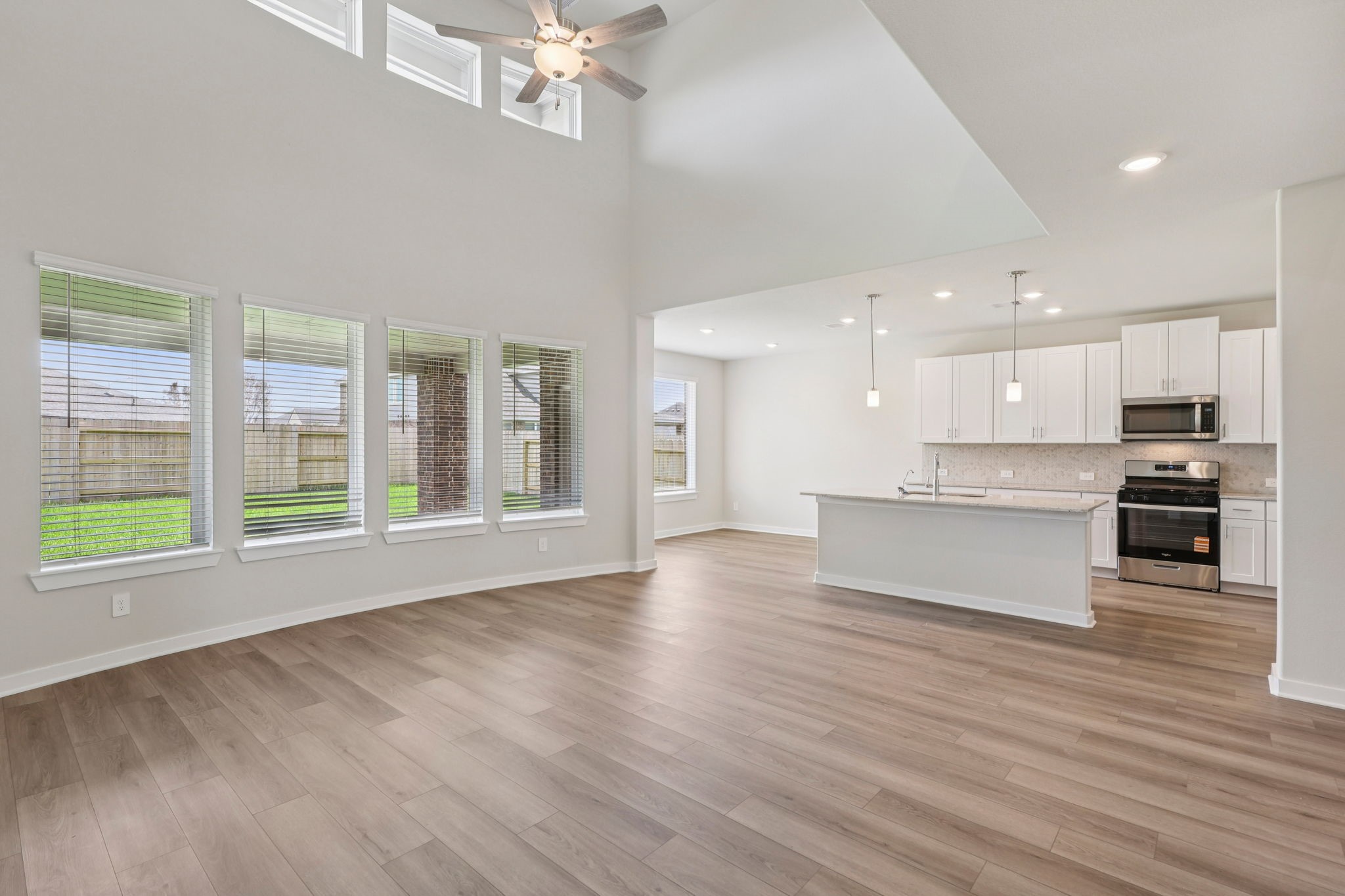 5519 Handlewood Lane Rosenberg, TX 77471 - Photo 10 of 38 a large kitchen with stainless steel appliances granite countertop a stove and a large window