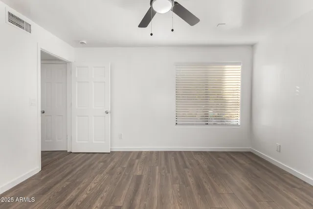 a bathroom with a granite countertop sink a toilet and a mirror
