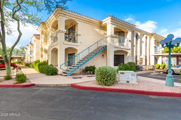 a view of a house with potted plants
