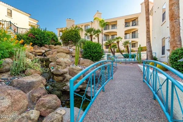 a view of a patio with couches table and chairs potted plants and palm tree