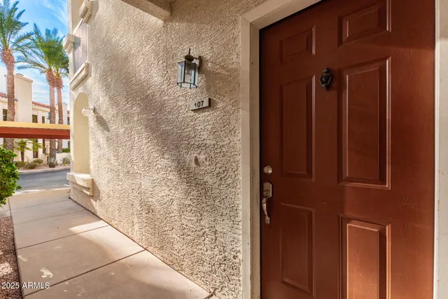a view of empty room with wooden floor and ceiling fan