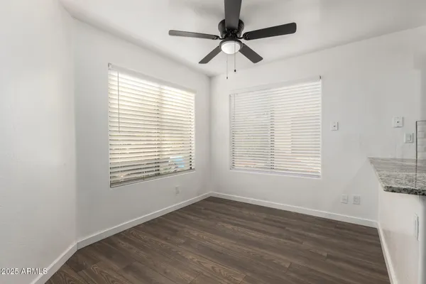 a kitchen with granite countertop a sink cabinets and stainless steel appliances