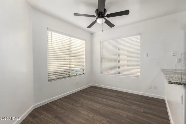 a kitchen with granite countertop a sink cabinets and stainless steel appliances