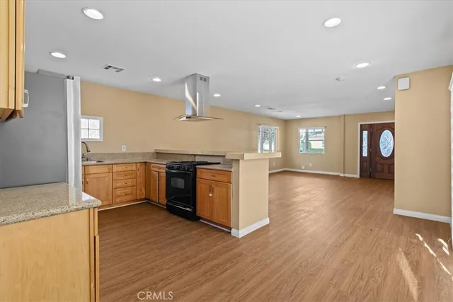 a view of a kitchen with a sink and a stove top oven