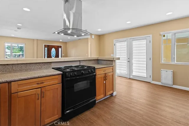a kitchen with stainless steel appliances granite countertop a stove and a sink