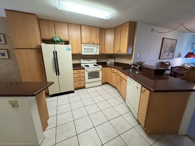 a kitchen with a refrigerator sink stove and cabinets
