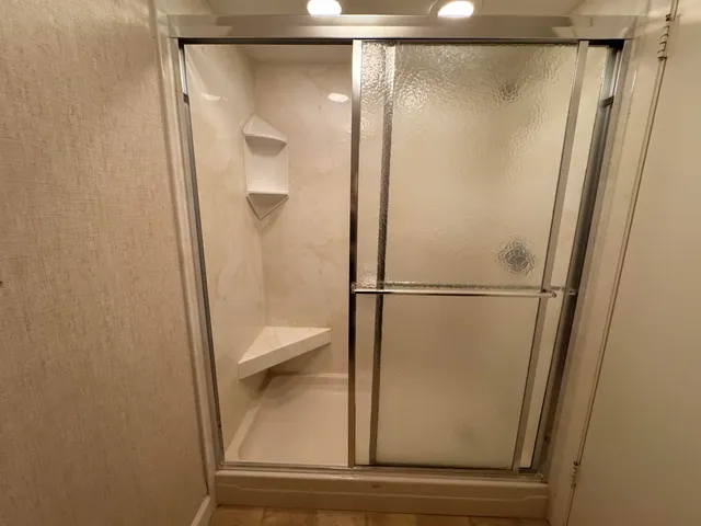 a bathroom with a glass shower door
