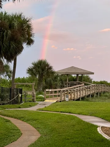 a view of green field with house in the background