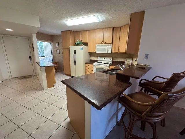 a kitchen with a refrigerator a stove top oven a sink and dishwasher