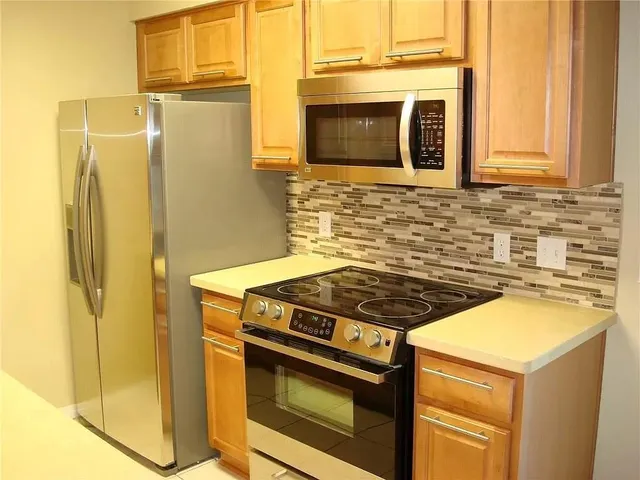 a stove top oven sitting inside of a kitchen