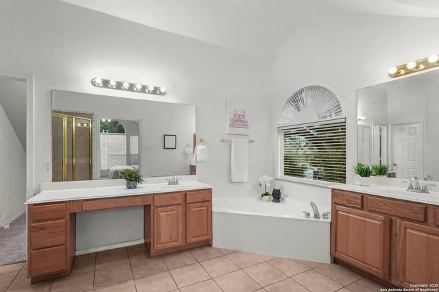 a bathroom with a tub sink and mirror