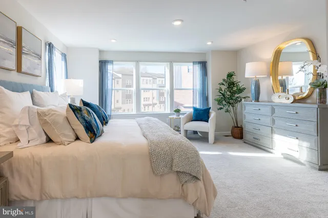 a spacious bedroom with a bed and window