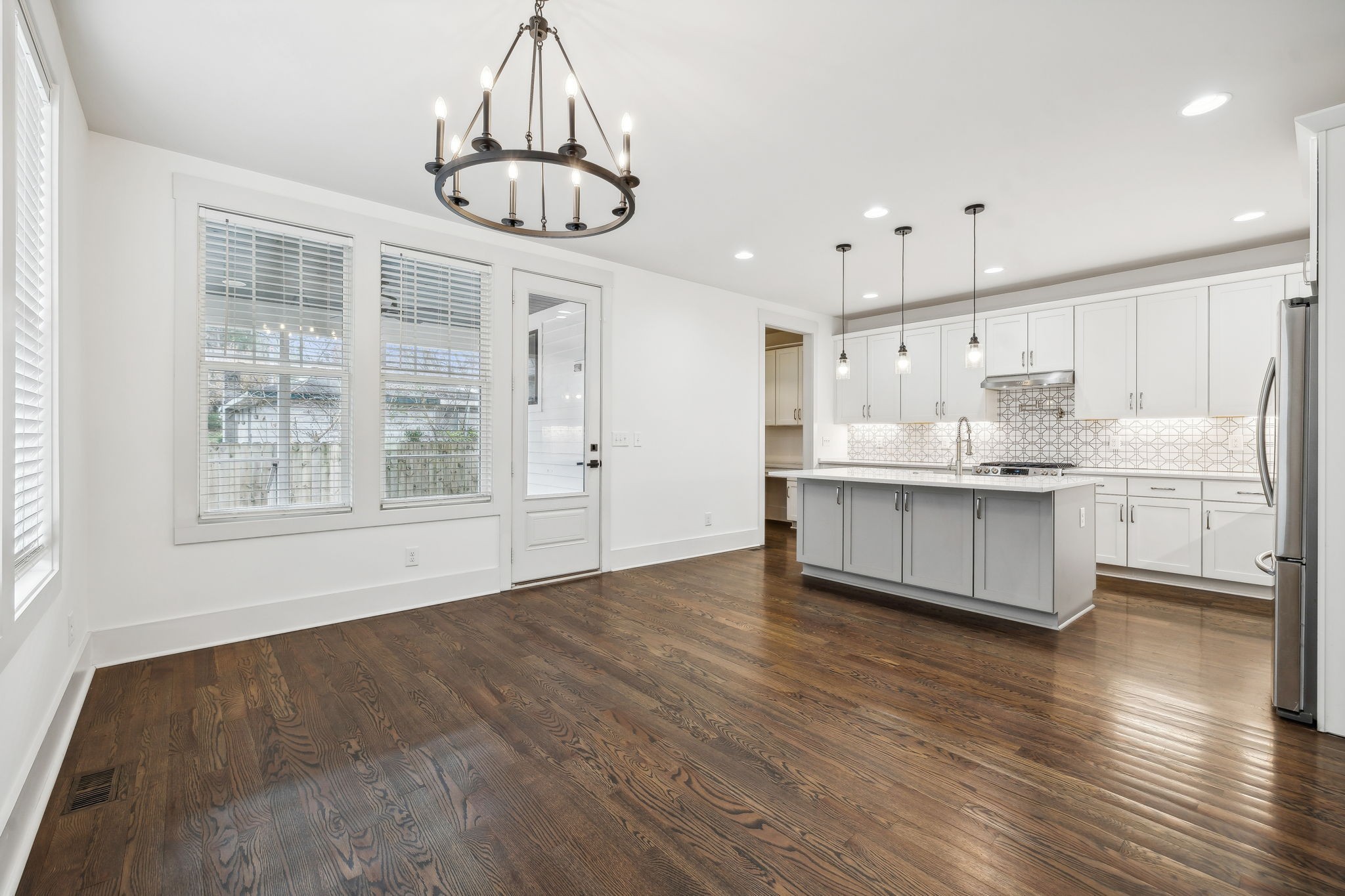 159 Acton Street Franklin, TN 37064 - Photo 32 of 70 a large kitchen with stainless steel appliances a large counter top a sink cabinets and wooden floor