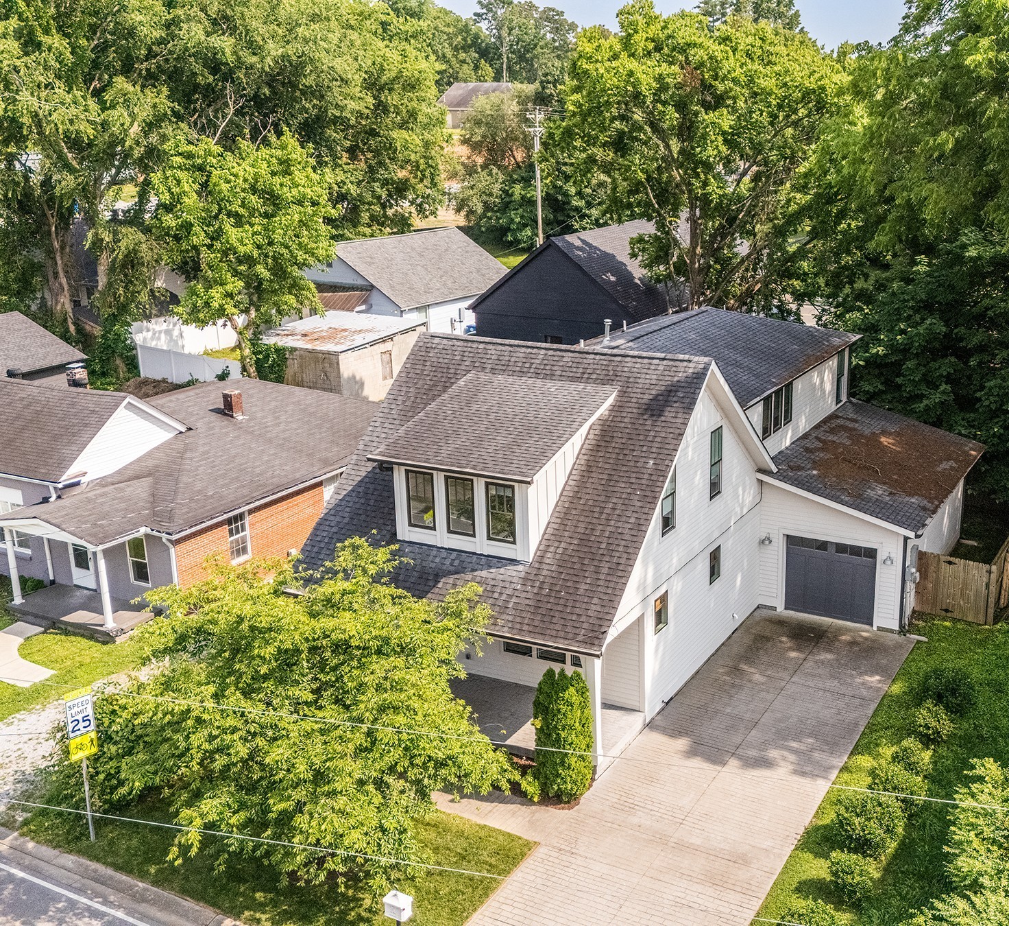 159 Acton Street Franklin, TN 37064 - Photo 58 of 70 a view of a white house next to a yard with potted plants
