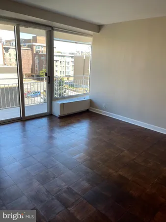 a view of an empty room and wooden floor