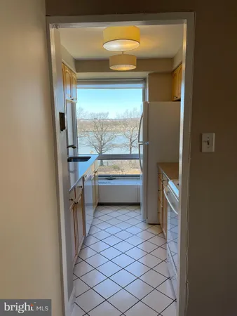 a kitchen with a sink a stove and cabinets
